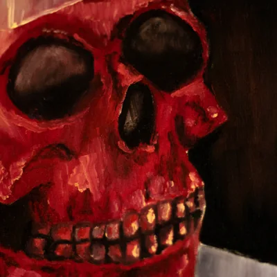 Detail of 'Suffering': the red skull's eye sockets and teeth